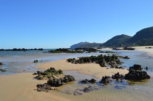 a beach with some rocks in the water at Apartamento Calas in Noja