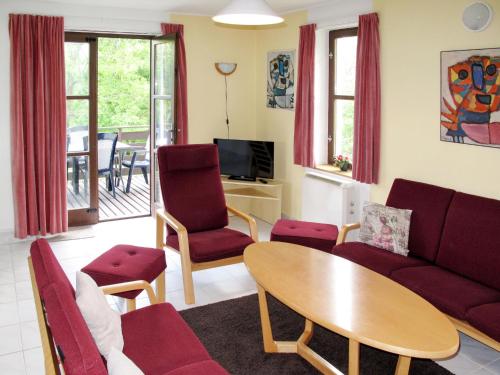 a living room with a couch and a table and chairs at Holiday Home Stárkov by Interhome in Stárkov