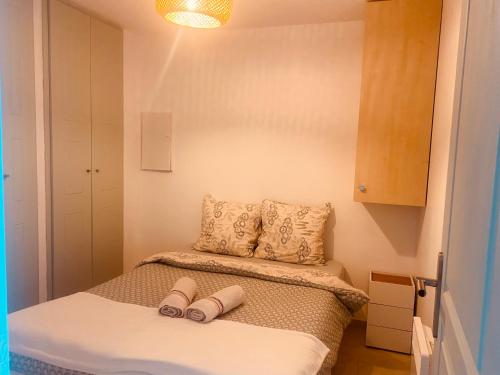 a small bedroom with a bed with two pillows at Sunny Home Costa Plana-Monaco -Cap D'Ail in Cap d'Ail