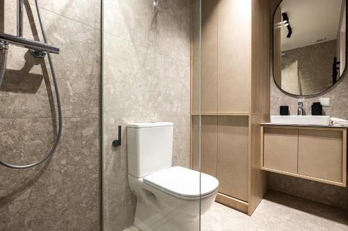 a bathroom with a toilet and a shower and a sink at Baltic Pine Retreat W/Balcony, By Cohost in Palanga