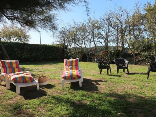 a group of chairs sitting in the grass at Holiday Home Ty Kerzo by Interhome in Plouhinec