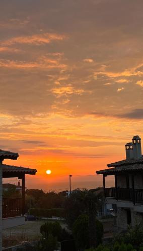 a sunset from the balcony of a house at Your Afytos Home in Afitos