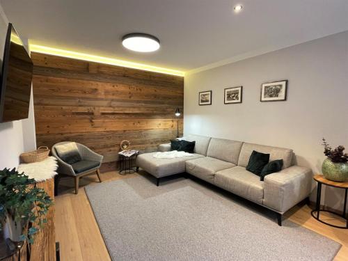 a living room with a couch and a chair at Apartment Panorama Chalet Tirol by Interhome in Auffach