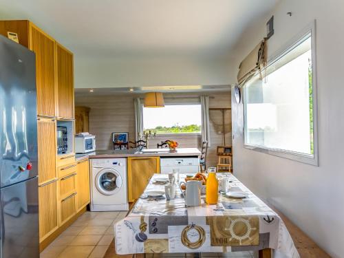 a kitchen with a washer and dryer at Holiday Home La Belle Vue by Interhome in Locquirec