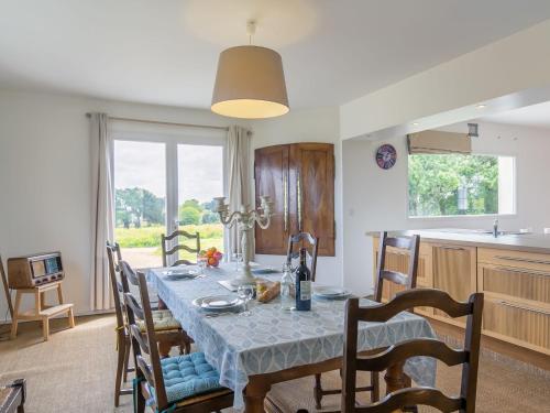 a kitchen and dining room with a table and chairs at Holiday Home La Belle Vue by Interhome in Locquirec