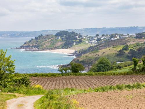 a view of a beach and the ocean from a hill at Holiday Home La Belle Vue by Interhome in Locquirec