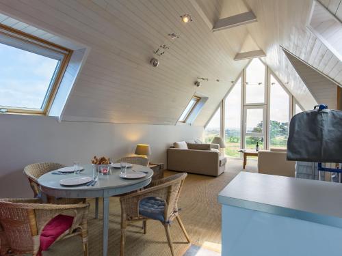 a living room with a table and chairs at Holiday Home La Belle Vue by Interhome in Locquirec