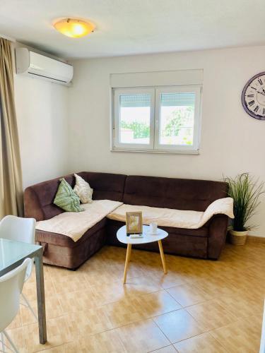 a living room with a couch and a table at Apartments Juraković in Živogošće