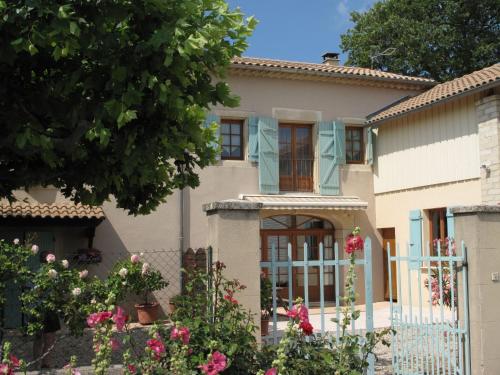 a house with a fence and flowers at Holiday Home Le Mas by Interhome in Grillon
