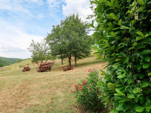 a group of carts in a field with trees at Holiday Home La Chênaie by Interhome in Oraison