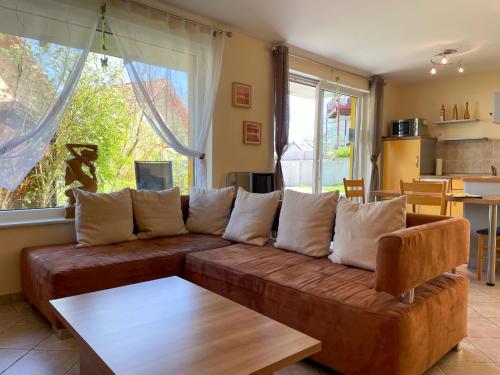 a living room with a brown couch and a table at Apartment Müritz Ferienpark Röbel-15 by Interhome in Röbel