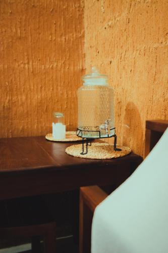 a candle on a table next to a wall at Yakaduru - Yala in Yala