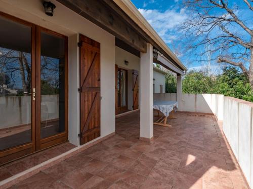 une terrasse couverte avec des portes coulissantes en verre dans l'établissement Holiday Home Agula Marina by Interhome, à Moriani-Plage