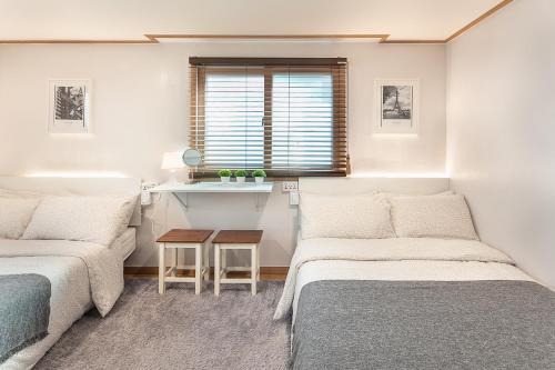 a living room with two beds and a table at Studio41 in Seoul