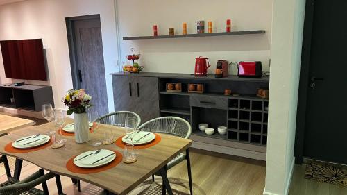 a dining room with a wooden table and chairs at City Metro Apartment in Quatre Bornes