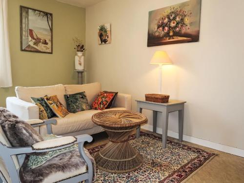 a living room with a couch and a table at Holiday Home La douce Trégoroise by Interhome in Tréguier