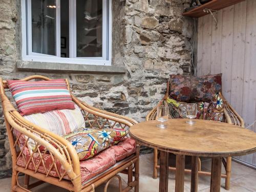 a table and two chairs and a table and a table and chairs at Holiday Home La douce Trégoroise by Interhome in Tréguier