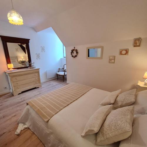 une chambre avec un lit, une commode et un miroir dans l'établissement Appartement Le Lioran By Les Monts du Cantal, à Murat