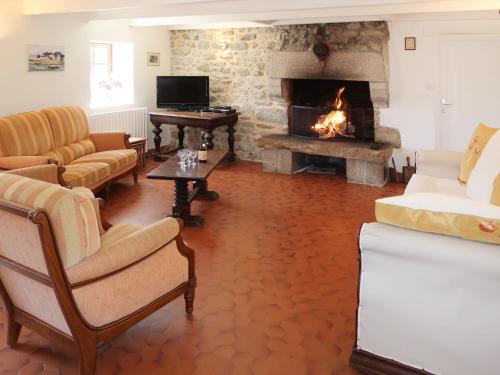 プルエスカにあるHoliday Home Ker Iliav by Interhomeの暖炉とソファと椅子のあるリビングルーム
