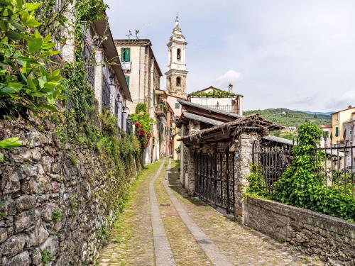 an alley in an old town with a clock tower at Apartment Asplanato - DOL166 by Interhome in Lecchiore