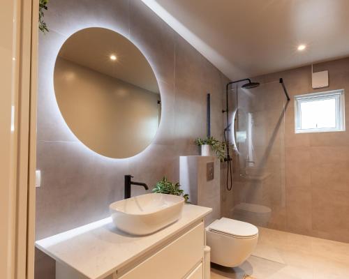a bathroom with a sink and a mirror at Deluxe Family Apartment in Egilsstaðir in Egilsstaðir