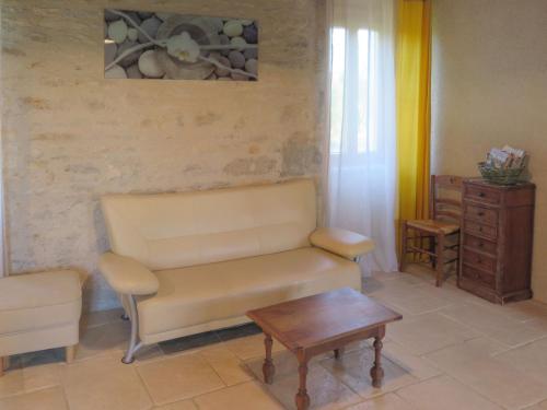 a living room with a couch and a table at Holiday Home Le Causse du Cluzel by Interhome in Pontcirq