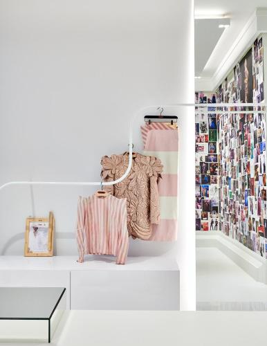a white room with a rack of clothes at De L’Europe Amsterdam – The Leading Hotels of the World in Amsterdam