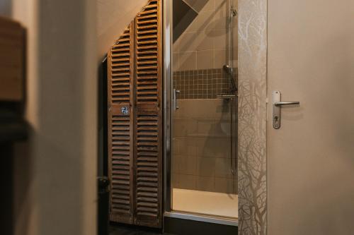 a bathroom with a shower with a glass door at La Villa in Mesnil-Val-Plage