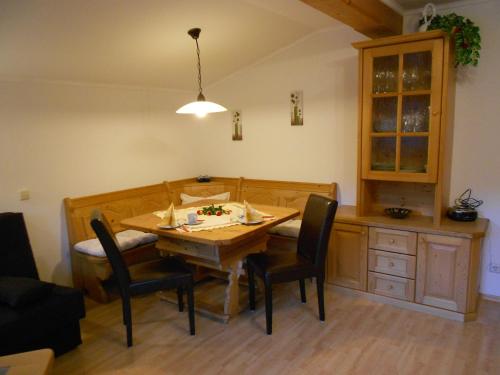 a dining room with a wooden table and chairs at Gästehaus Holzer in Viehhofen