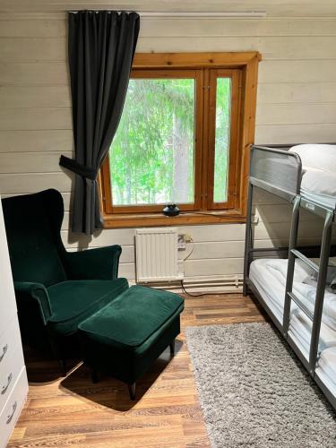 a bedroom with a bunk bed and a chair and a window at Gemuetliches Blockhaus im Wald in Auktsjaur