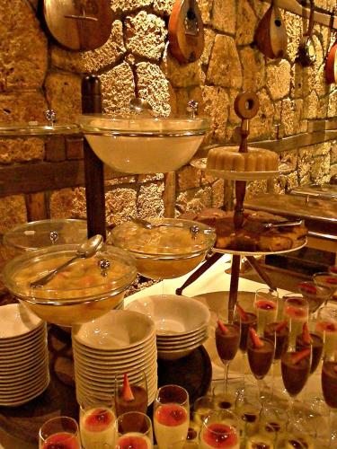 a buffet with plates and bowls and wine glasses at Estate Kalaitzis in Vergina