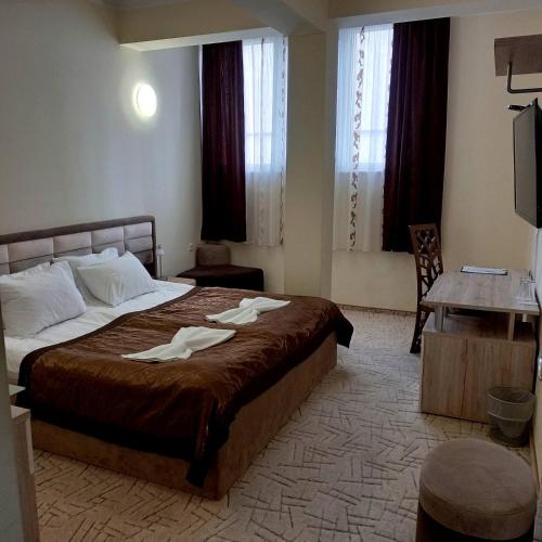 a hotel room with a bed with towels on it at Hotel Dream in Stara Zagora