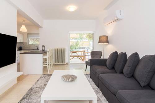 a living room with a couch and a table at Great Two Bedrooms Apartment in Varkiza in Vari