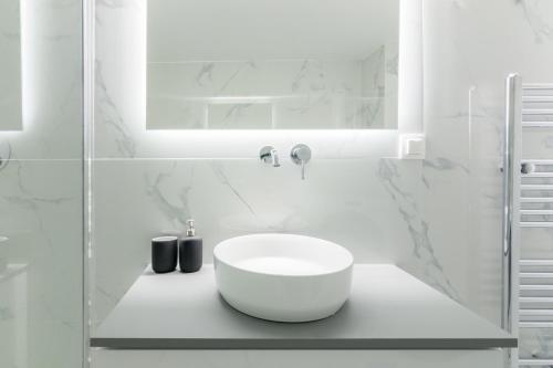 a white bathroom with a sink and a mirror at Great Two Bedrooms Apartment in Varkiza in Vari