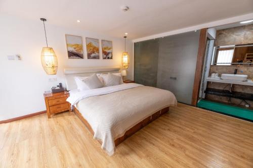 a bedroom with a large bed and a bathroom at Lijiang Old Town Meiliju View Inn in Lijiang