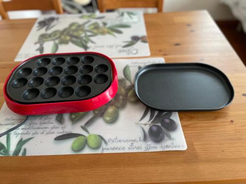 a red keyboard sitting on top of a wooden table at コンドミニアム　アガサンクス in Kuki