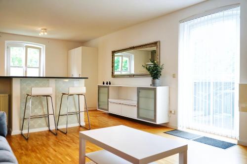 a living room with a counter and a mirror at Stilvolles Apartment in stadtnähe-Parkplatz- 4 Personen- Balkon in Wolfsburg