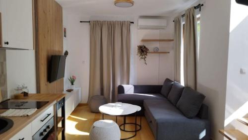 a small living room with a couch and a table at Royal Villa - HAWAII in Vrnjačka Banja