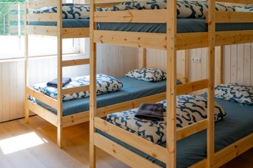 a bunk bed room with four bunk beds at Sodyba Ažvintis in Švedriškė
