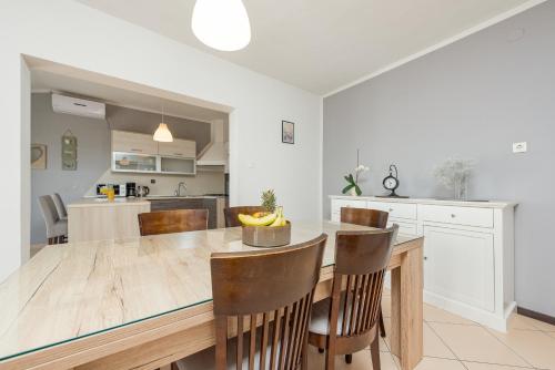a kitchen with a large wooden table and chairs at Apartman Mara in Poljica