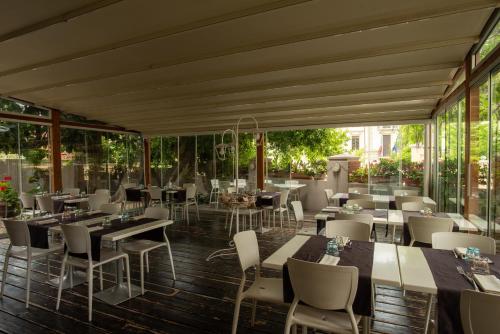a restaurant with tables and chairs and windows at Locanda dei Buoni e Cattivi in Cagliari