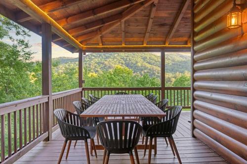 a wooden deck with a table and chairs on it at The Remedy at Blue Ridge - mountain view cabin with hot tub and two fire pits in Cherry Log