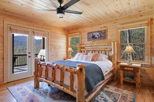 a bedroom with a bed and a ceiling fan at The Remedy at Blue Ridge - mountain view cabin with hot tub and two fire pits in Cherry Log