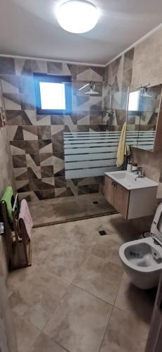 a bathroom with a toilet and a sink at Aх, морето in Burgas