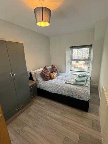 a small bedroom with a bed and a window at Quaint cottage close to Marina in Pembrokeshire