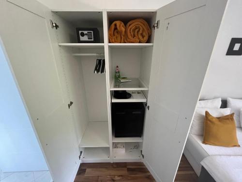 a room with white cabinets and a couch at Eva Luxury Rooms & Apartments in Plitvička Jezera