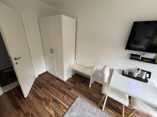 a small room with a white desk and a tv at Eva Luxury Rooms & Apartments in Plitvička Jezera