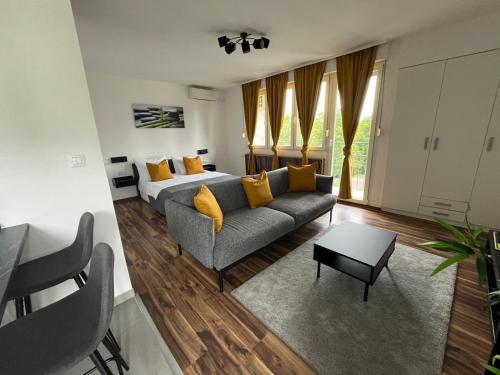 a living room with a couch and a bed at Eva Luxury Rooms & Apartments in Plitvička Jezera