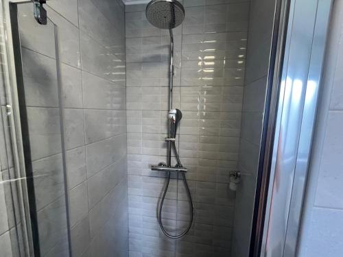 a shower with a shower head in a bathroom at Eva Luxury Rooms & Apartments in Plitvička Jezera