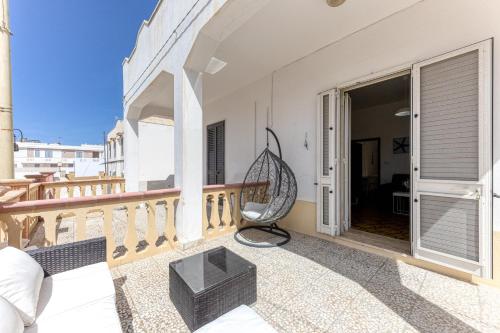 a balcony of a house with a chair at Dimora Ristola in Leuca